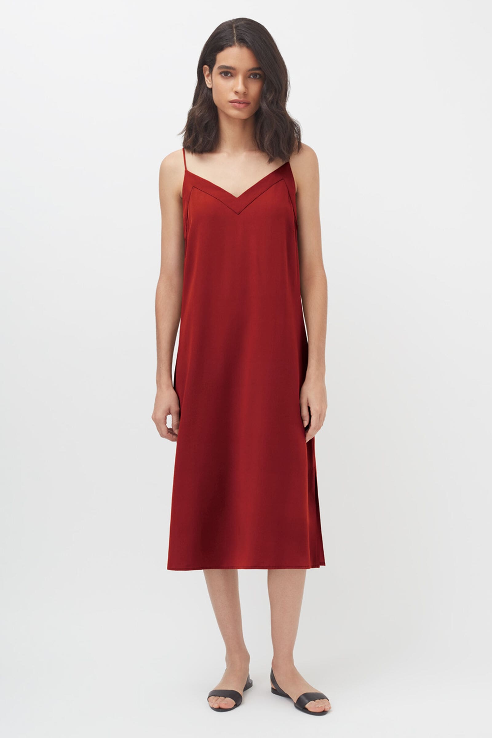 A model wears a red spaghetti strap slip dress.