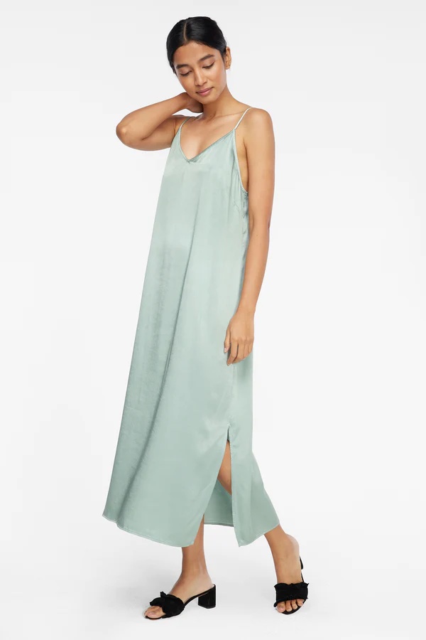 A model wears a silky, long, mint-green slip dress.