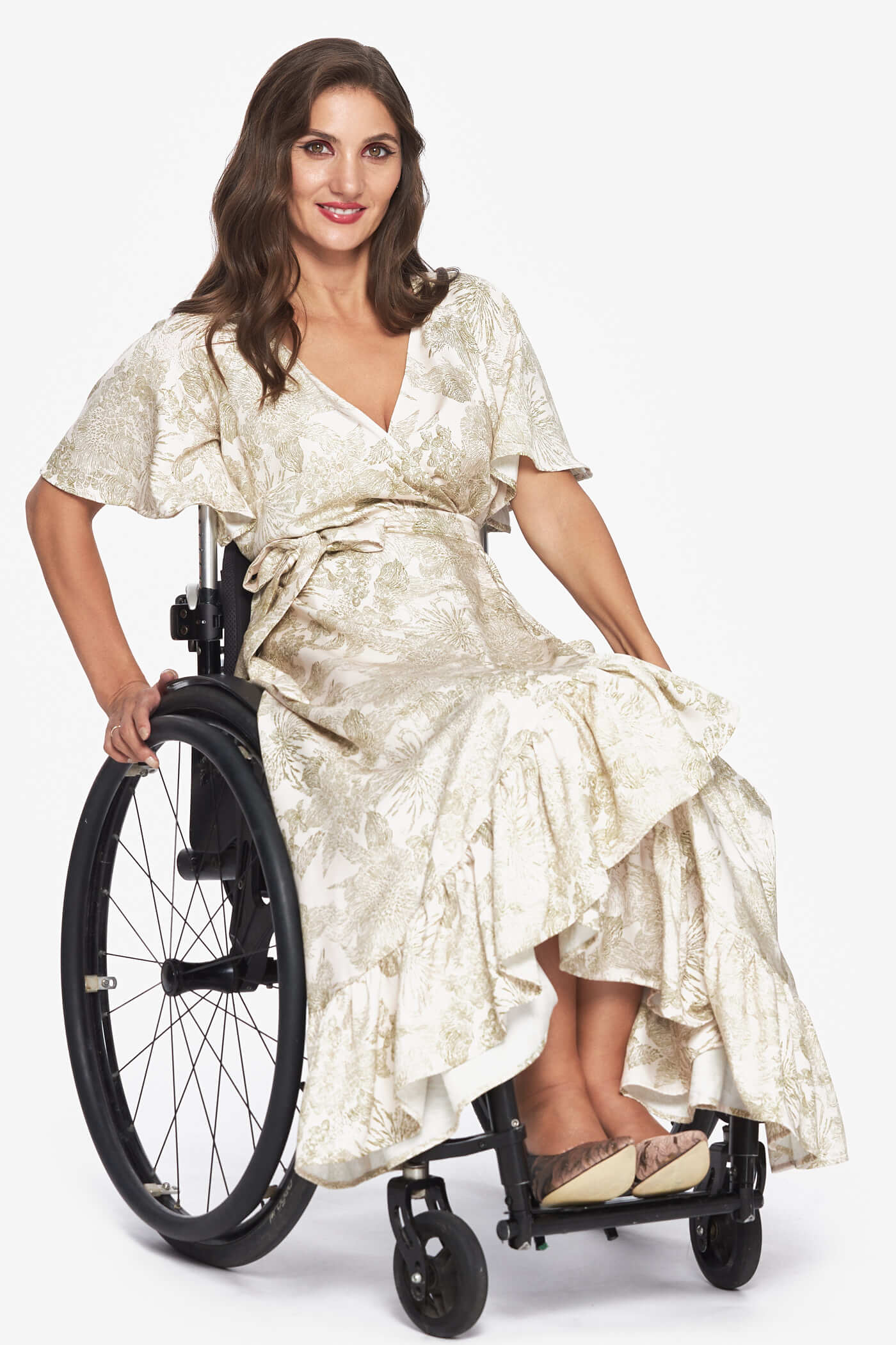 A model in a wheel chair wears a wrap dress