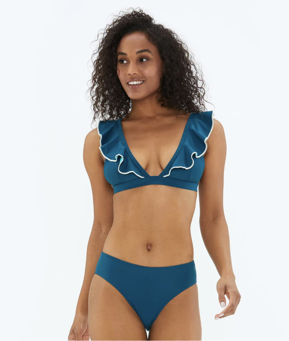 A model in a blue bikini with ruffle sleeves.