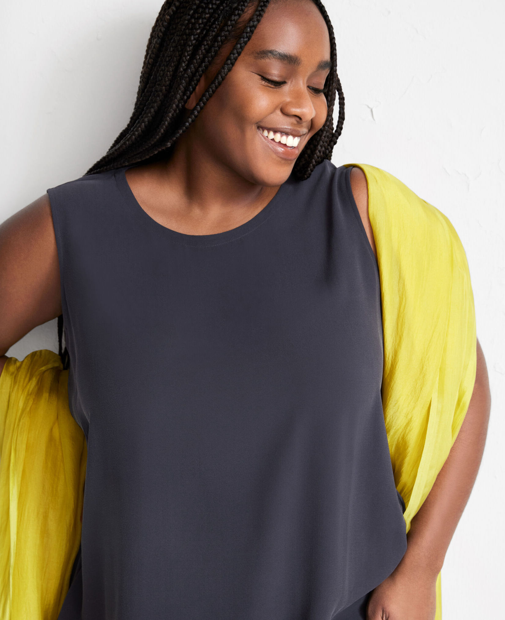 A plus size model in a tank and shawl.