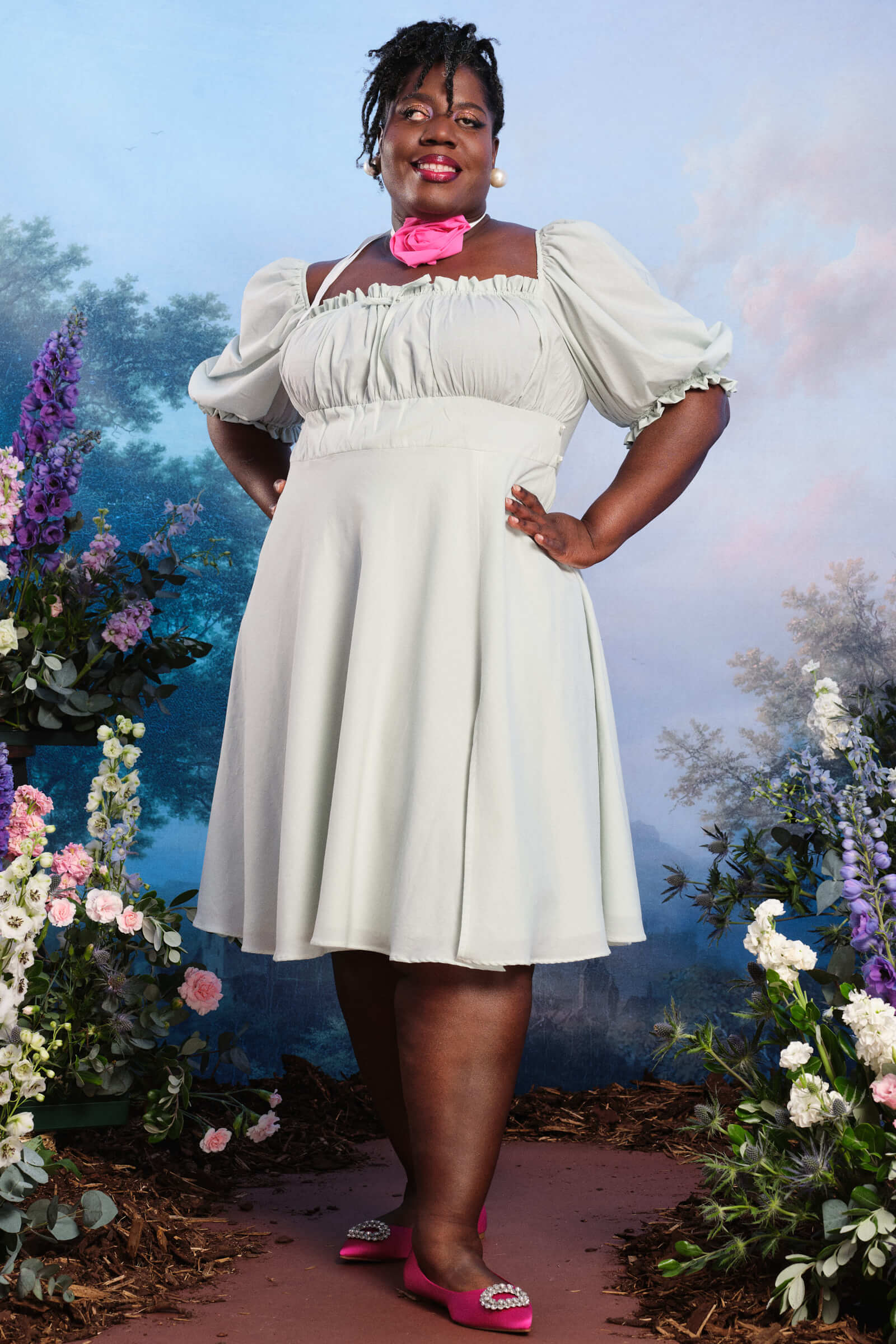A plus size model in a formal mint colored dress.