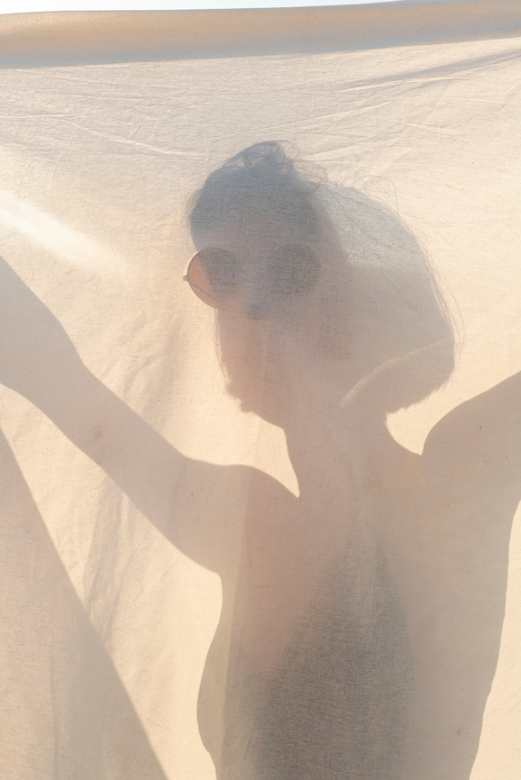 woman holding a white sheet