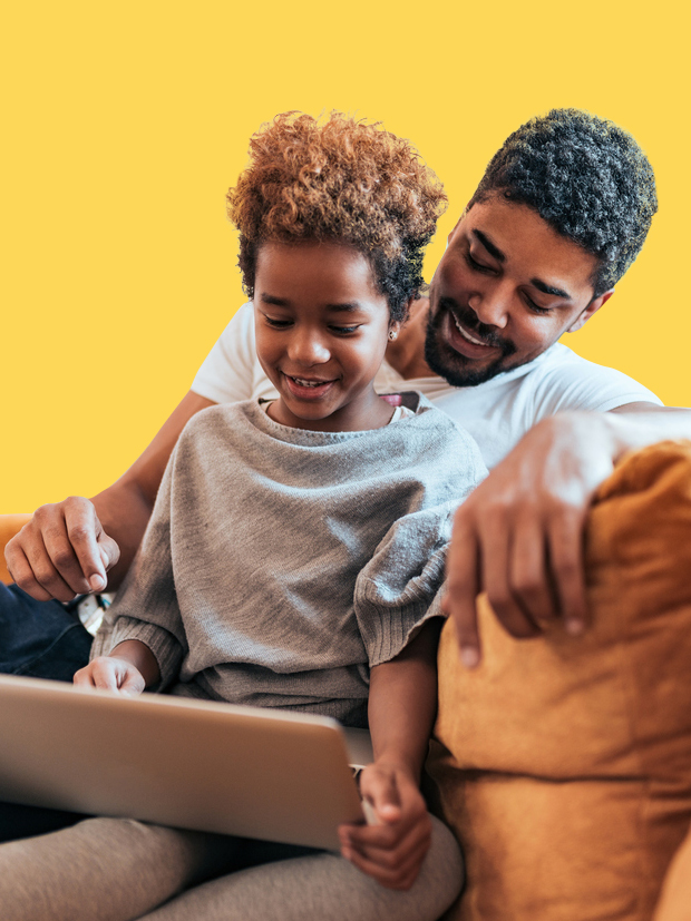 A dad and his child smile at a tablet screen. 