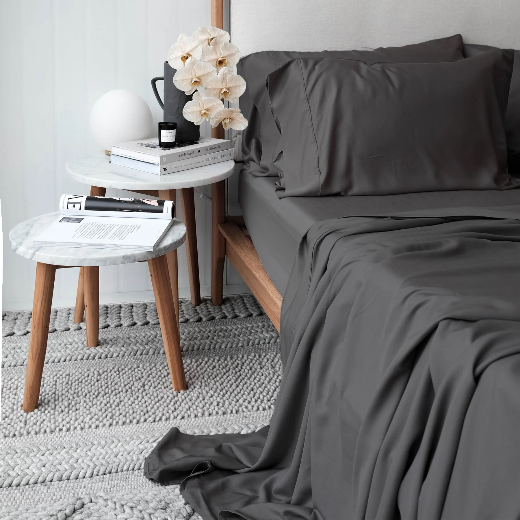 A bed made up in dark gray Tencel sheets. 