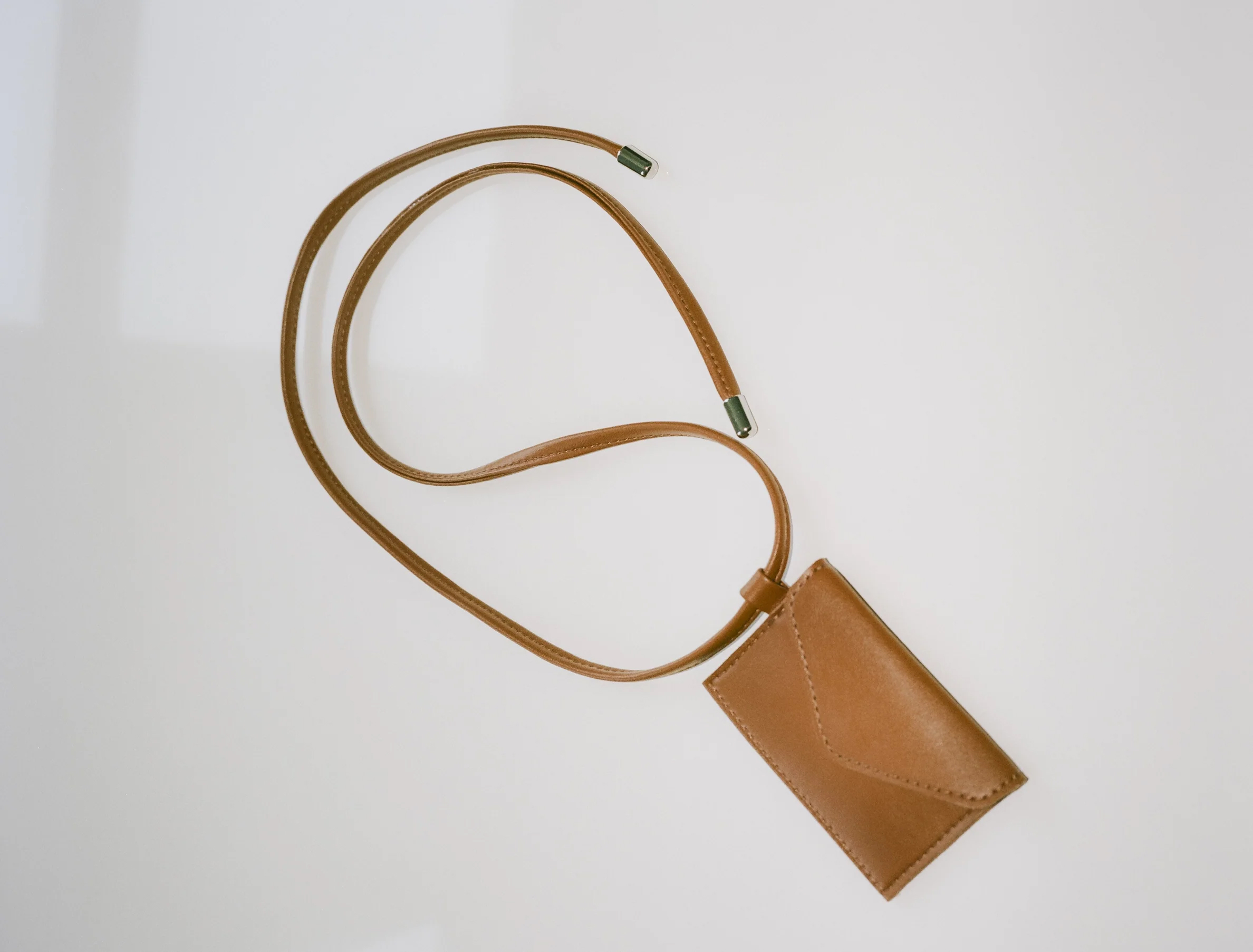 A brown card carryiing sling from hozen. 