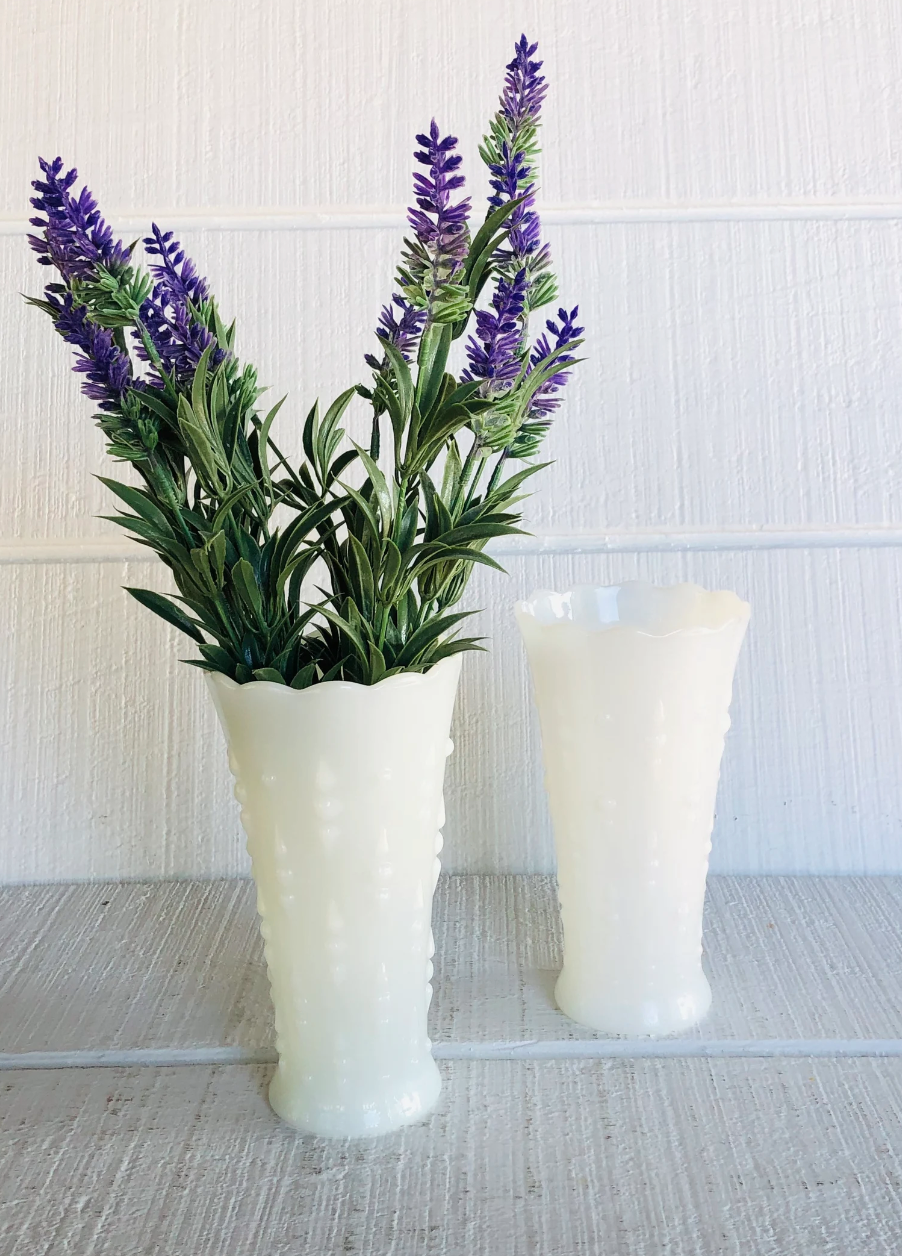 Milk glass vessels with flowers.