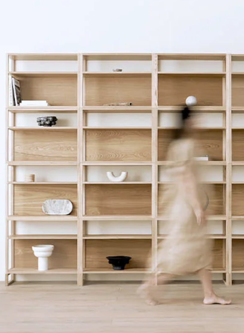 A NUMI shelf with a blurred figure walking by. 