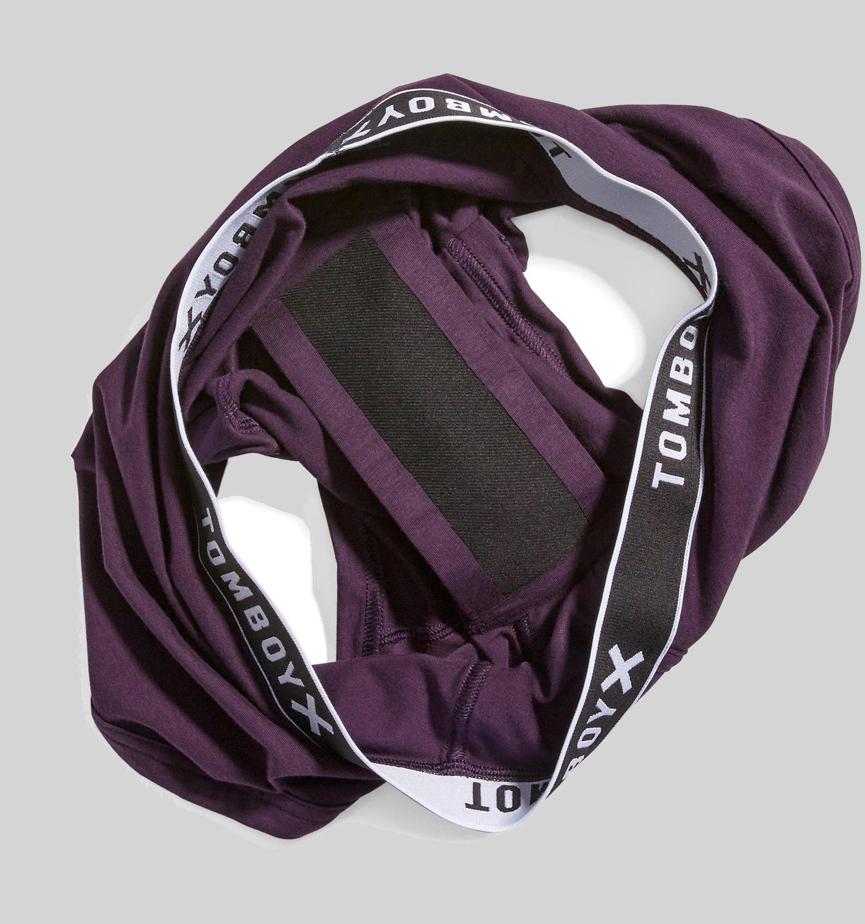A pair of purple TomboyX underwear inside out to show the gusset.