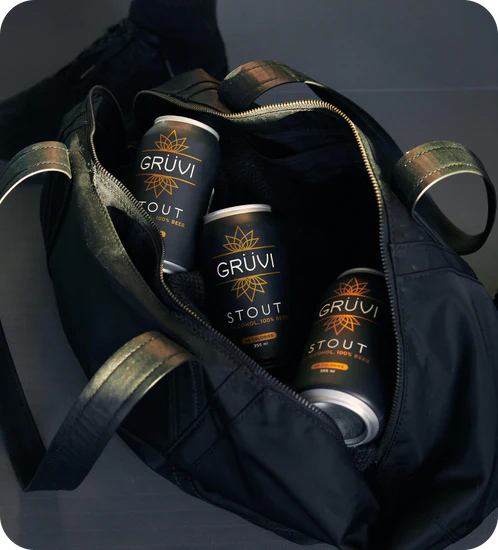 A bag sitting open to show three Grüvi cans inside.