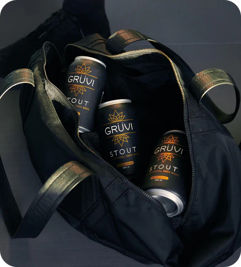 A bag sitting open to show three Grüvi cans inside. 