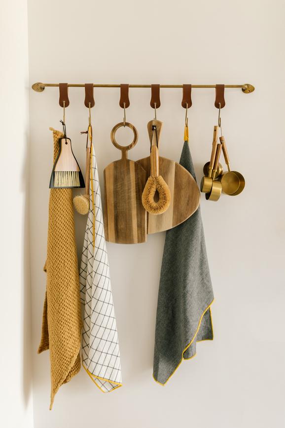Sustainable home goods hanging on a wooden rack.