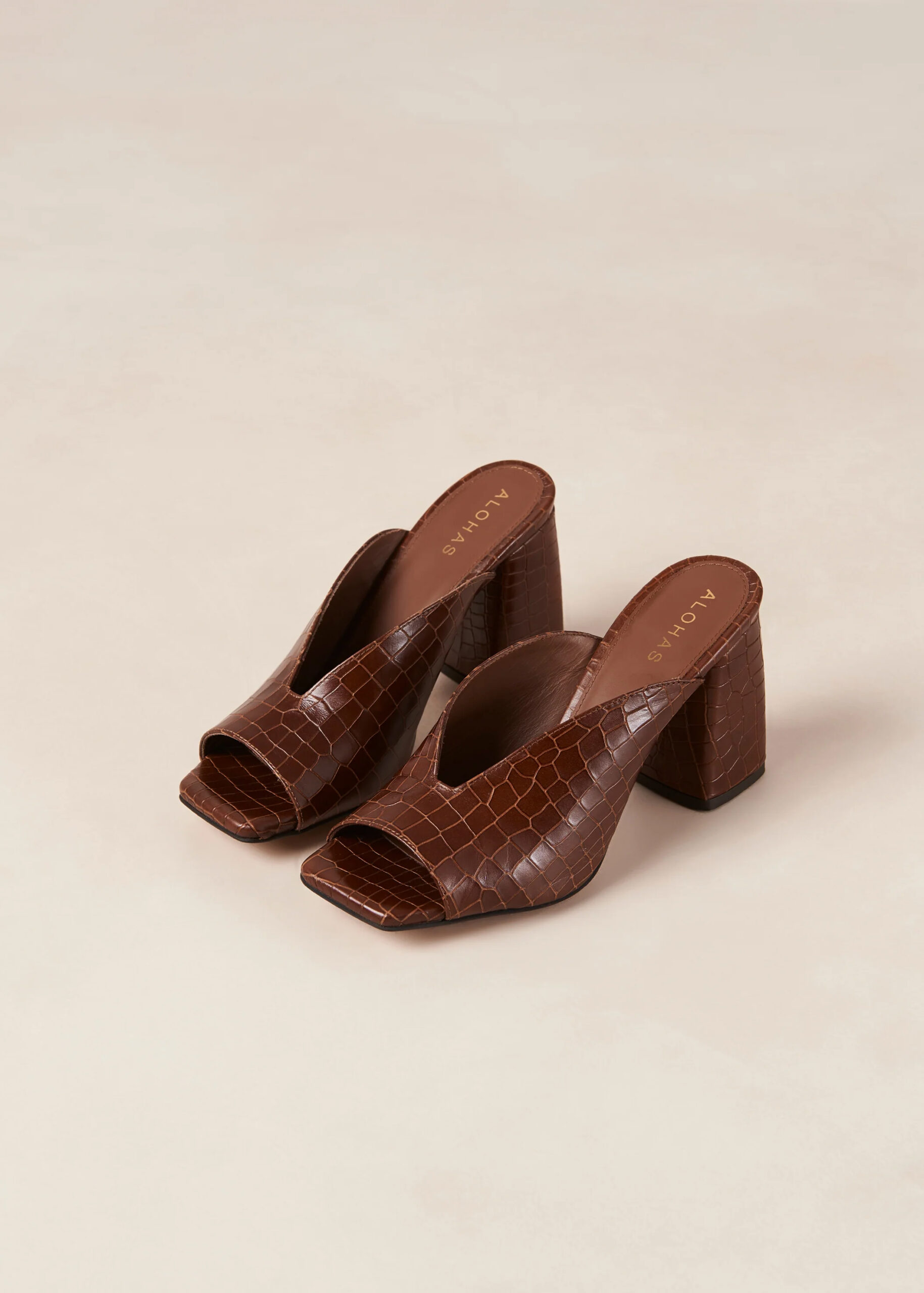 Brown crocodile-textured brown mule heels. 