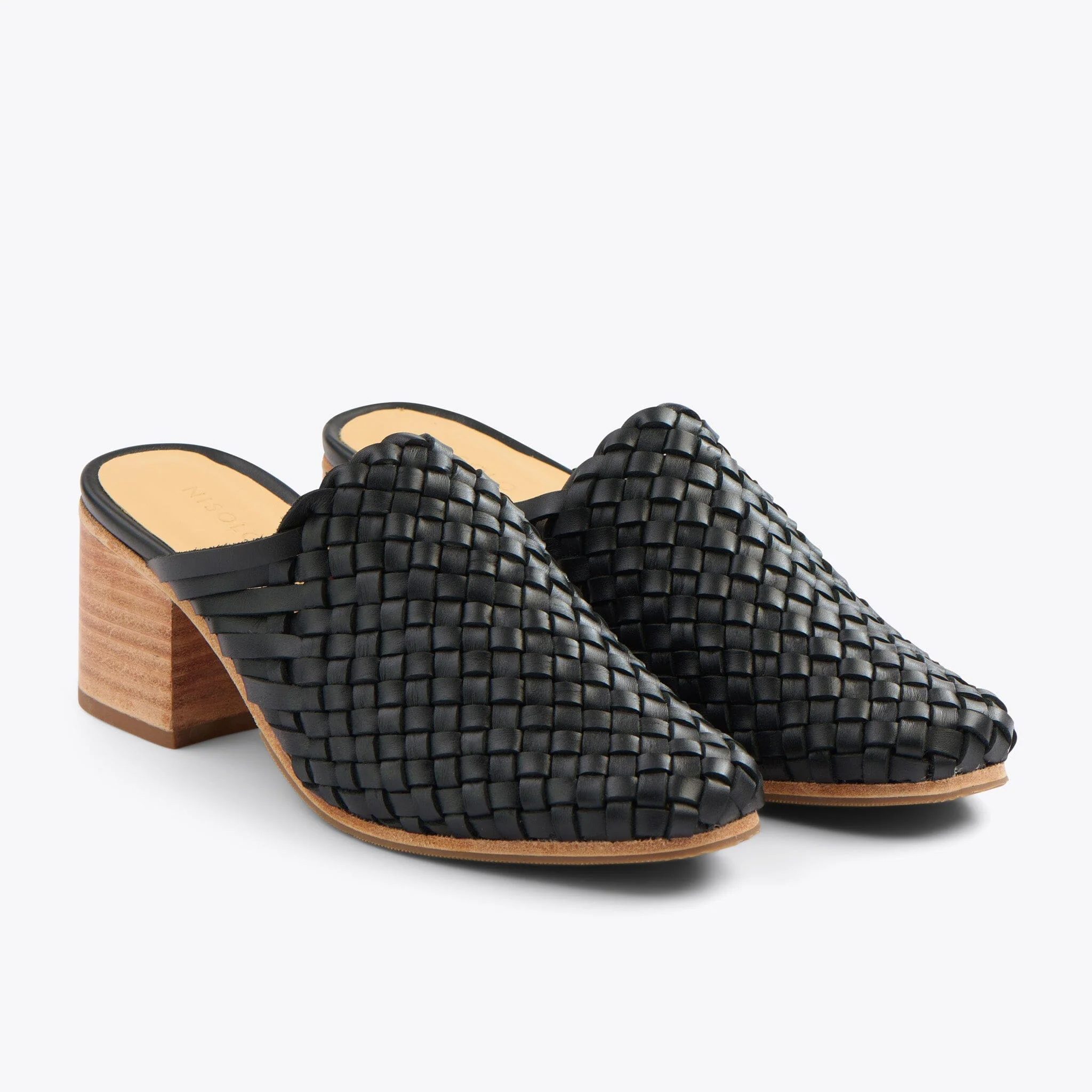 A pair of braided black mule heels. 