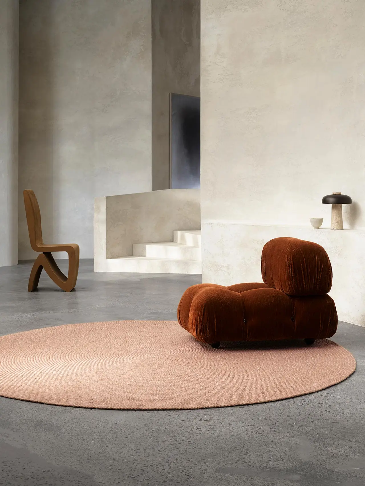 A nontoxic Armadillo round rug in a styled living room. 