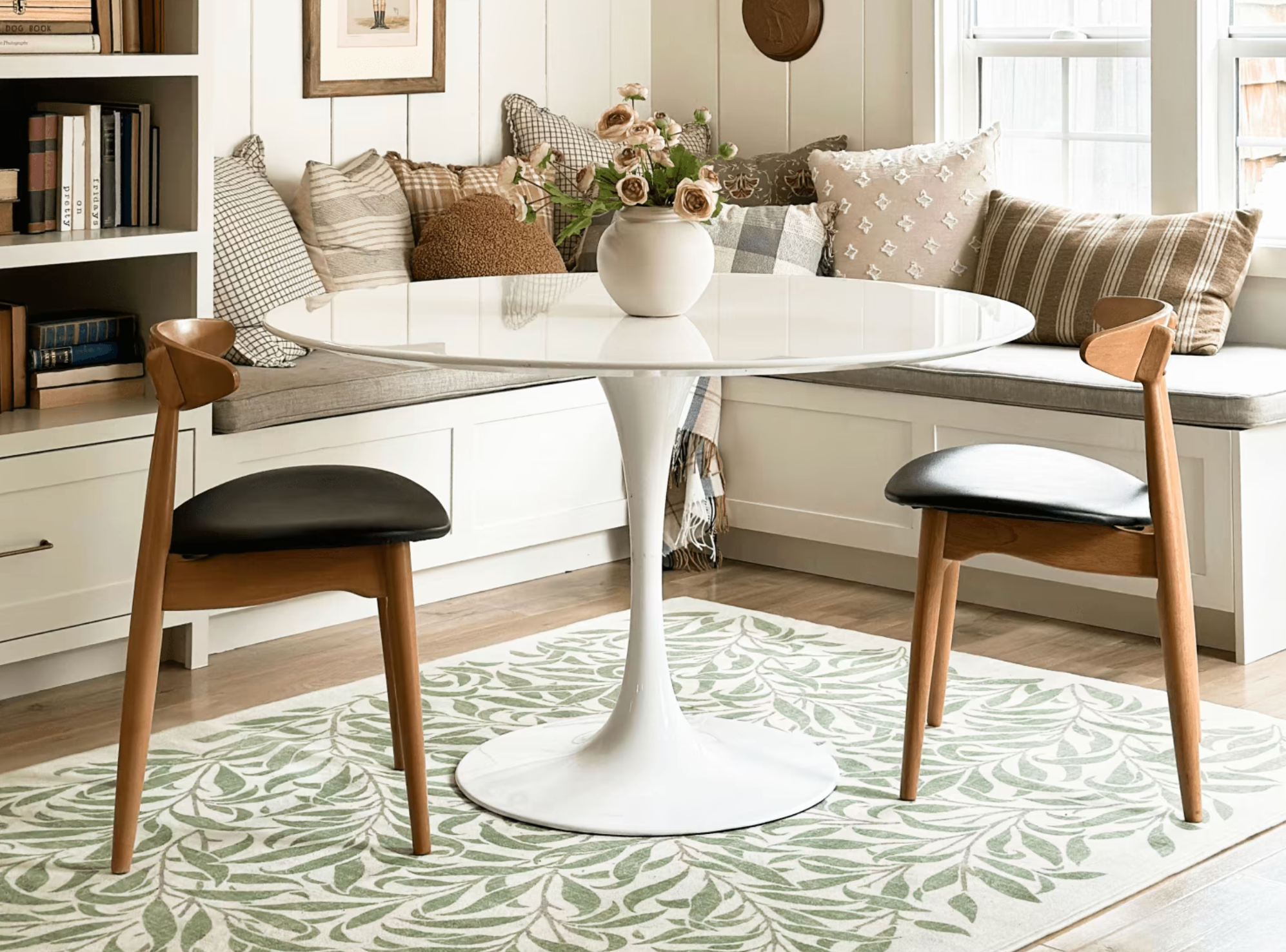 A round pedestal table in a styled dining nook with a nontoxic Ruggable rug. 
