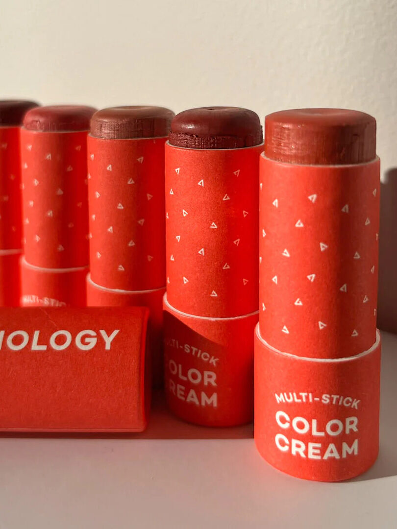 A row of Axiology multi-use color sticks in various shades.