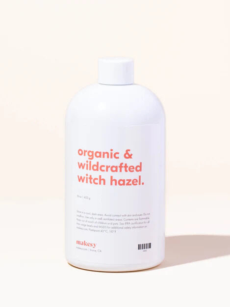 A white bottle of Makesy's Organic and Wildcrafted Witch Hazel Toner in front of a pale yellow background.
