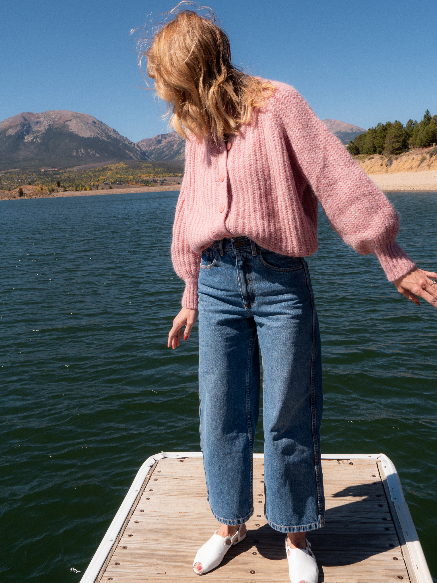 The writer wearing the Sézane Emile Cardigan and Le Crop jeans. 