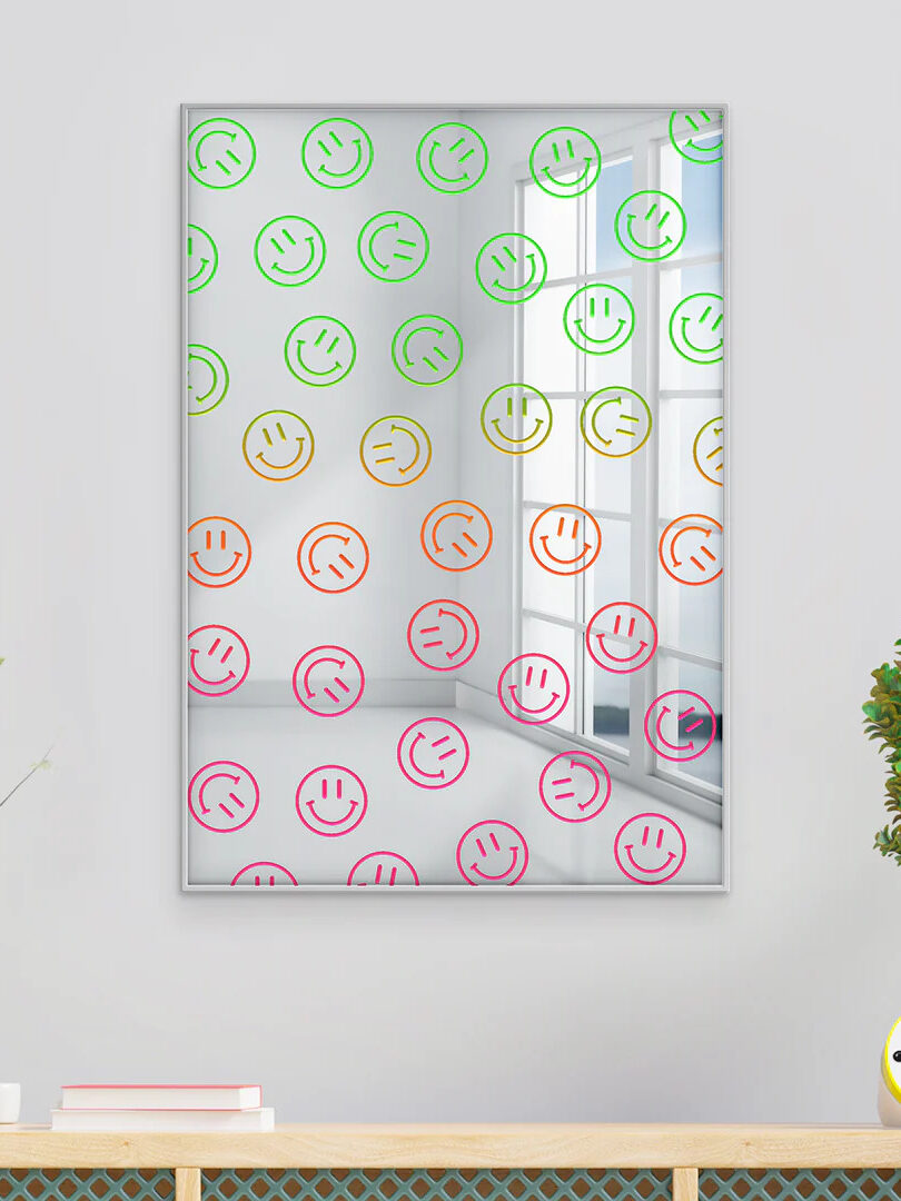 A rectangle mirror with green, yellow, orange and pink happy faces patterned throughout, by Afternoon Light. 