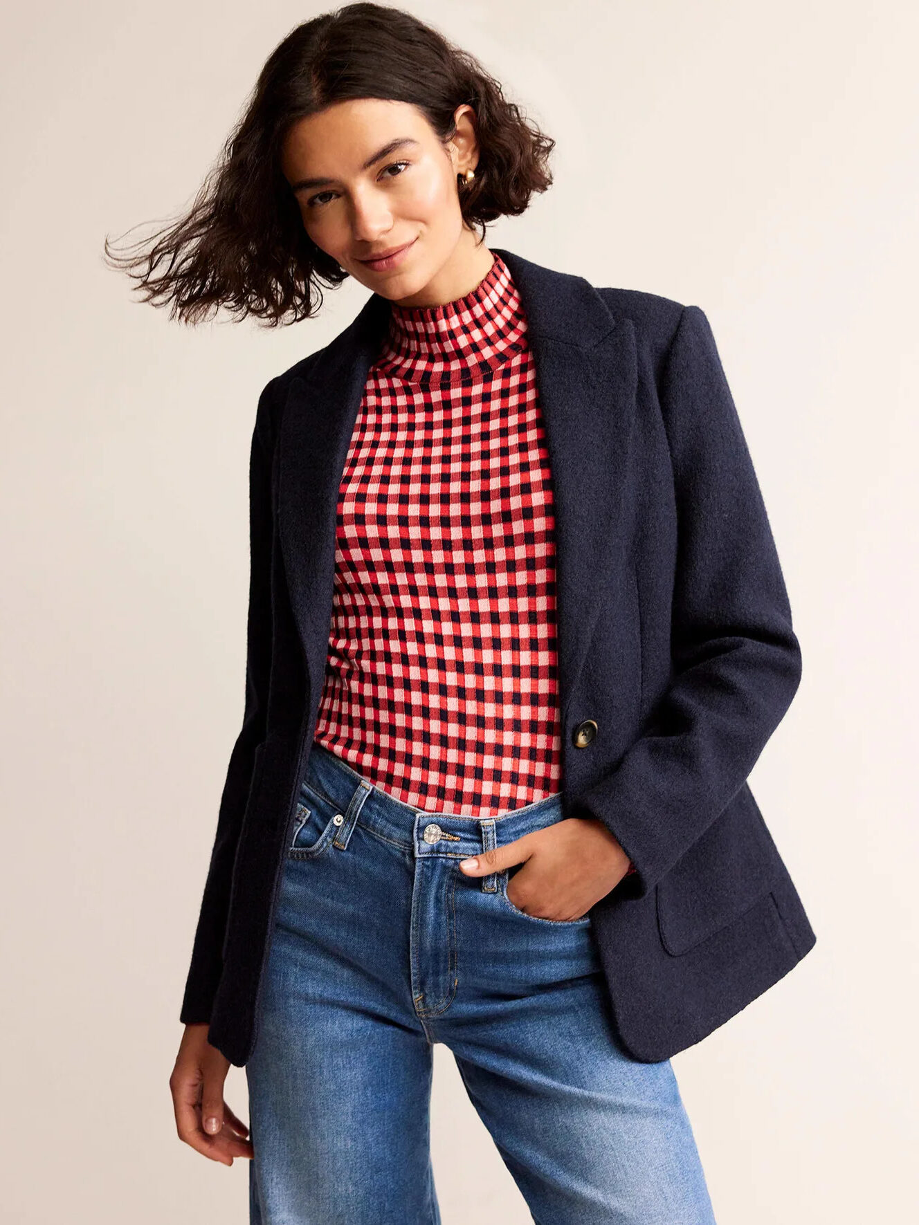 A model wearing a dark blue wool blazer by Boden.