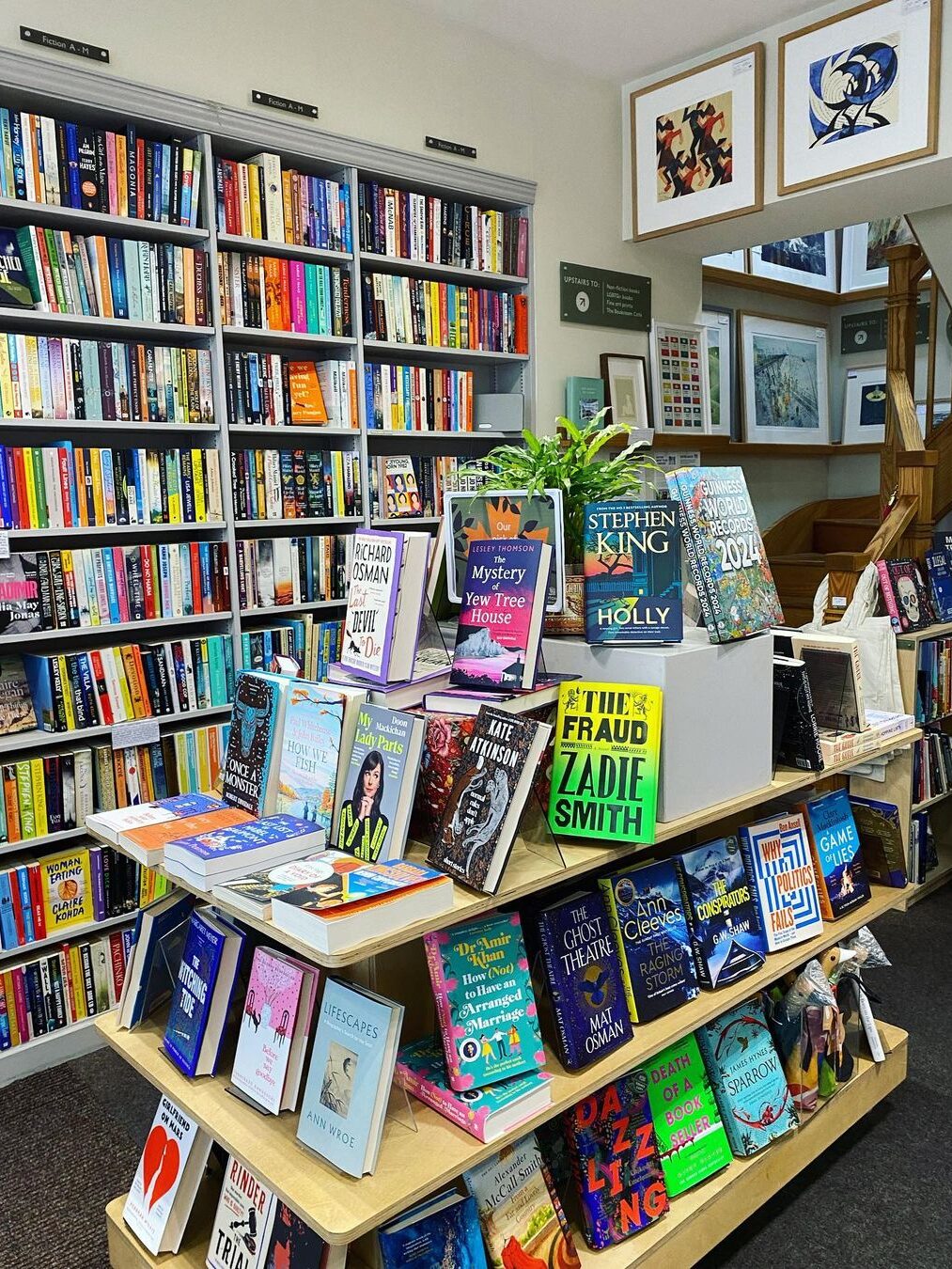 A bookshop with a three-shelf display in the center, covered with books from Bookshop.