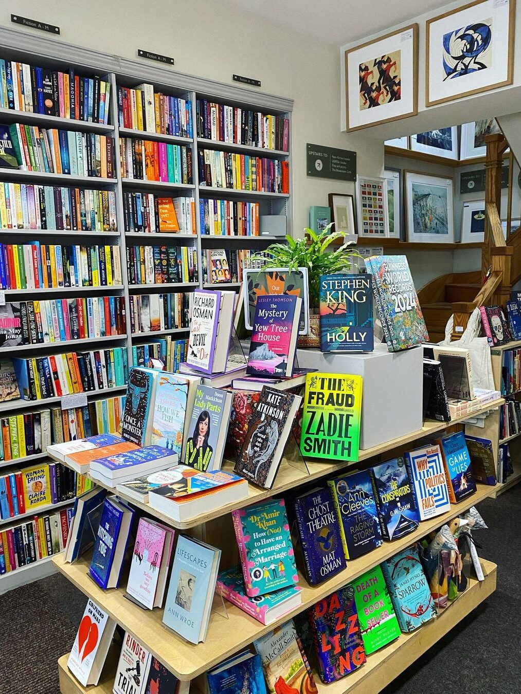 A bookshop with a three-shelf display in the center, covered with books from Bookshop. 