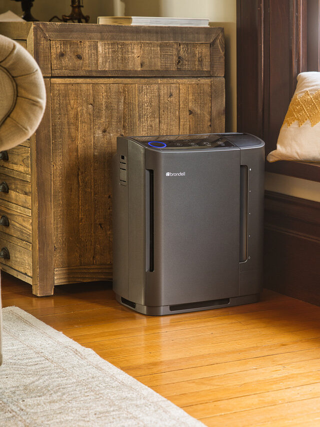 A grey/black Brondell air purifier in a living room.