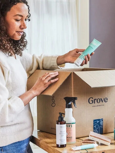 A model removing items from a Grove Collaborative shipping box 