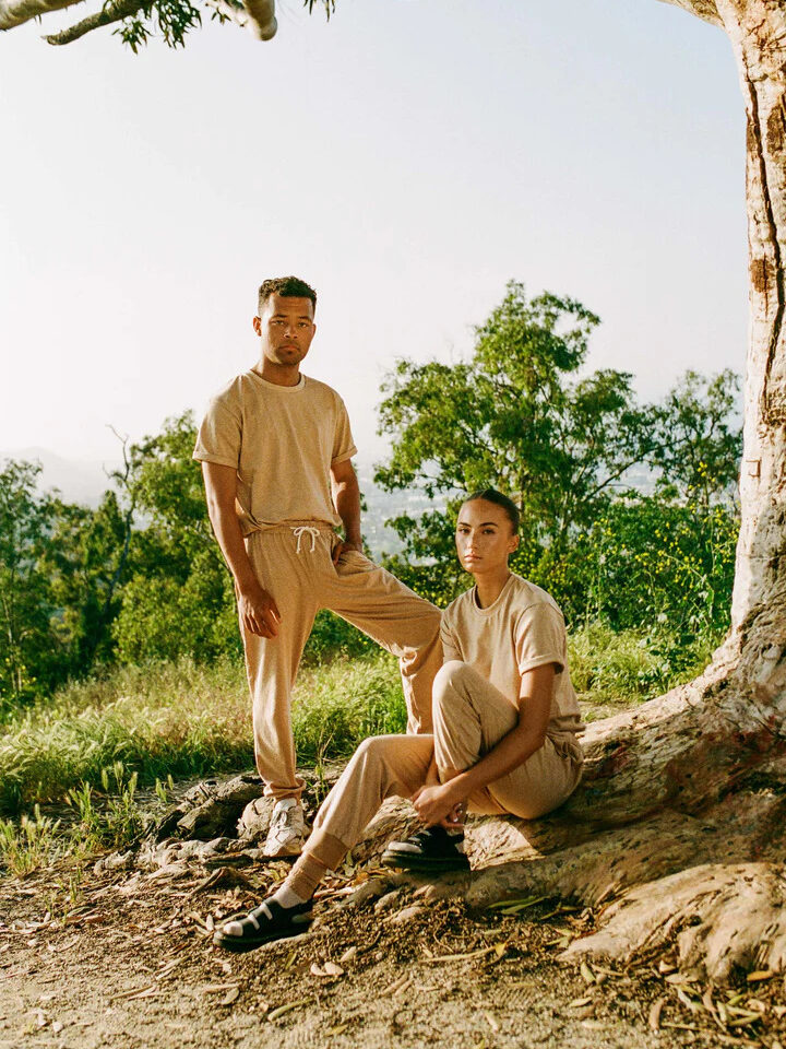 2 models wearing matching Harvest & Mill sweat sets in beige. 