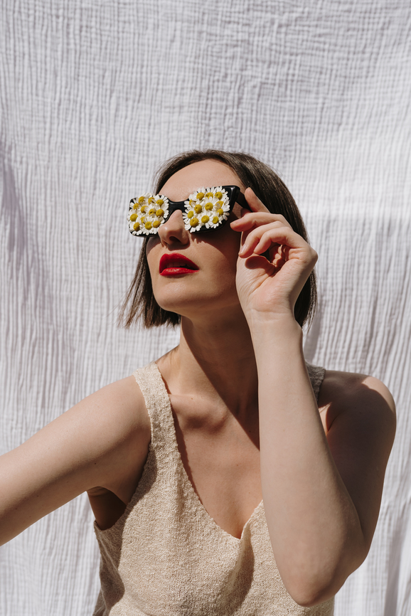 Young woman in chamomile glasses. Summer concept.