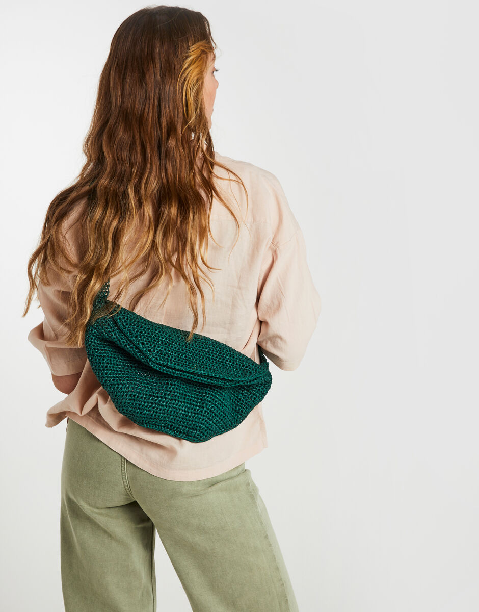 A model wearing a crotcheted crossbody bag from Wool and the Gang.