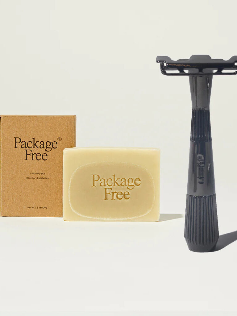 A bar of Package Free shaving soap and a Package Free black razor.