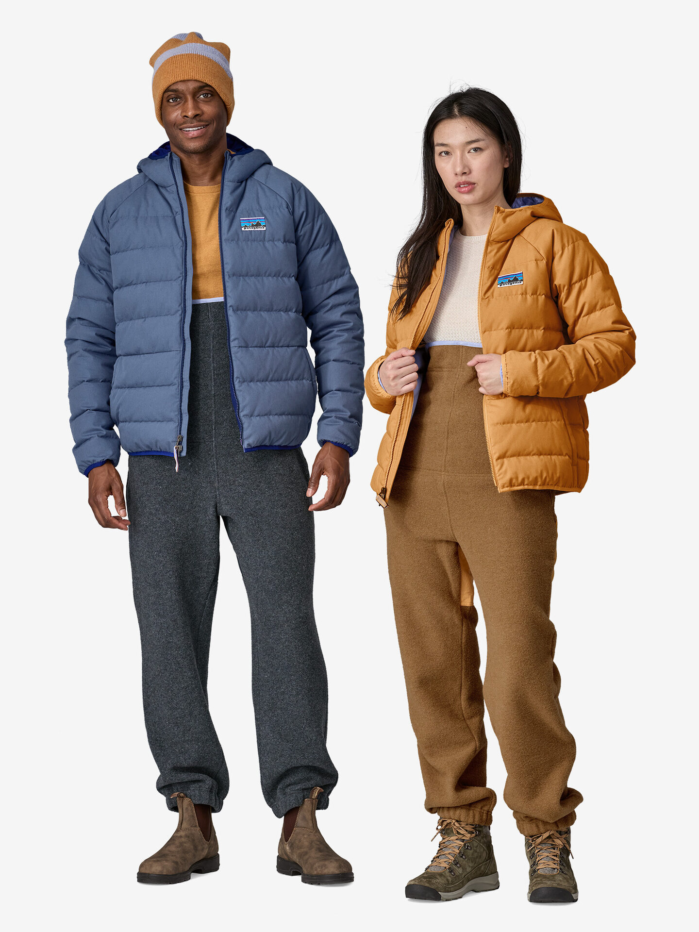 2 models wearing Patagonia puffer jackets in blue and burnt orange. 