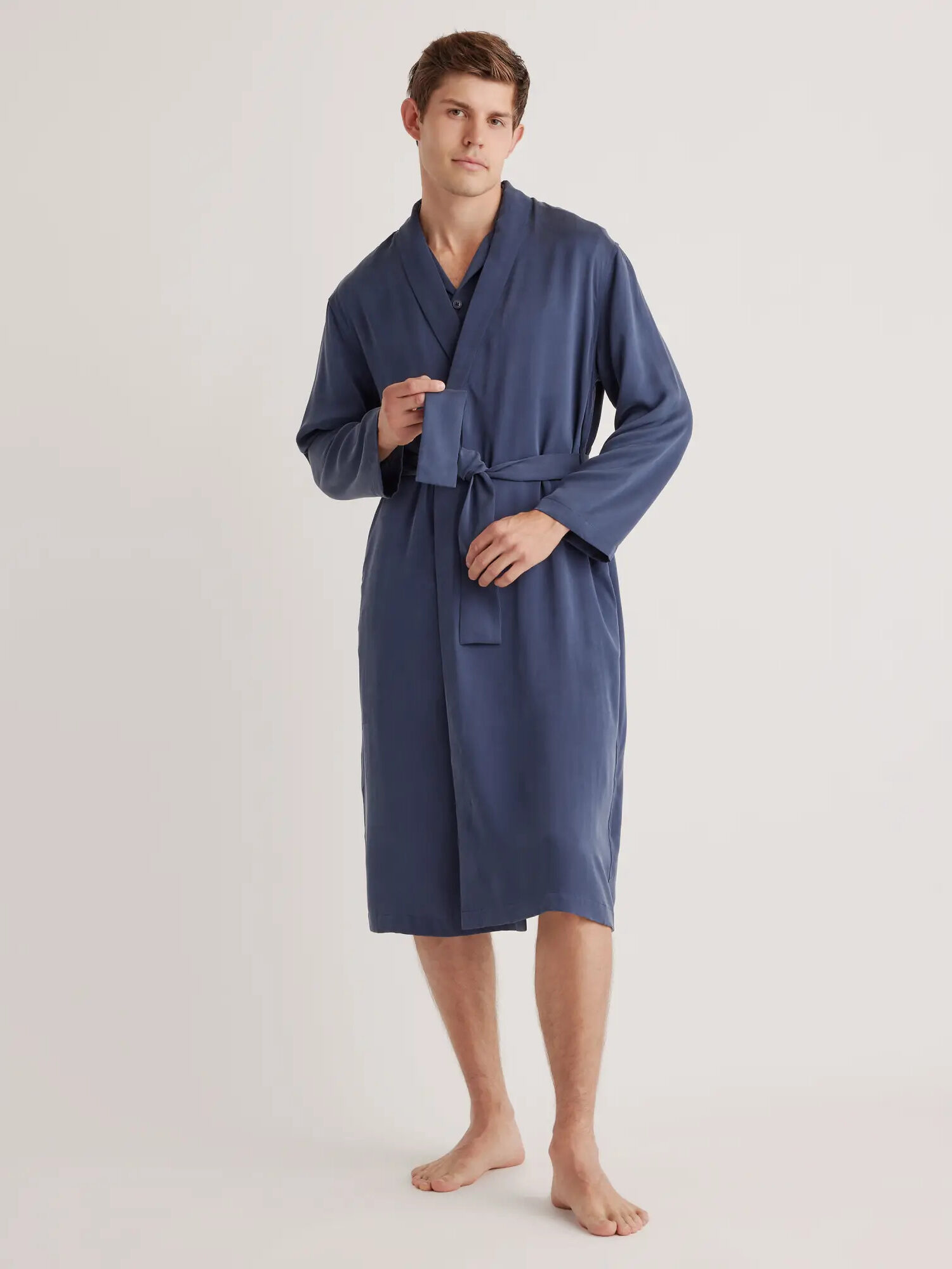 A model wearing Quince's washable silk robe in blue.