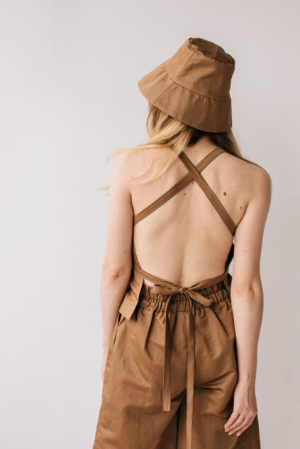 Unrecognizable woman wearing brown clothes and hat