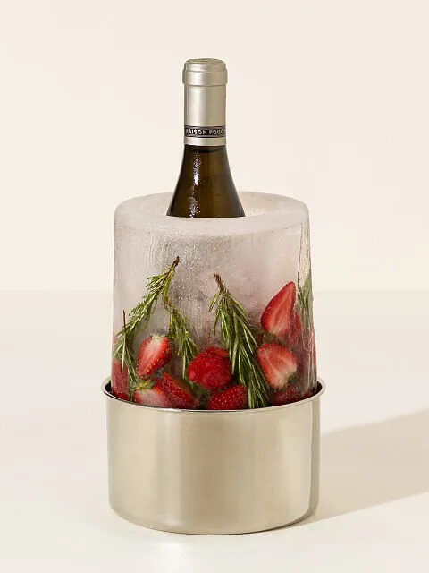 A wine/champagne aluminum chiller that looks like ice with strawberries and rosemary frozen into the ice. By Uncommon Goods.