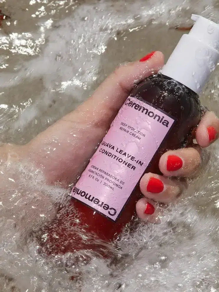 A hand holding Ceremonia Leave-In Conditioner