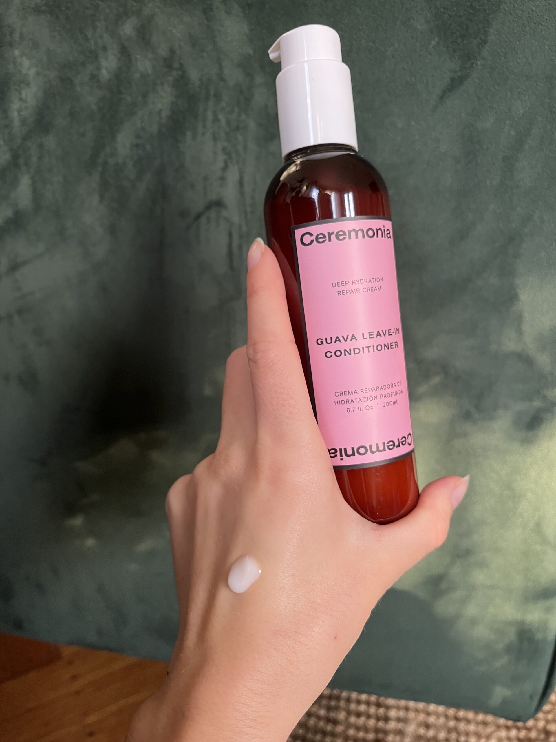 A hand holding Ceremonia Leave-In Conditioner