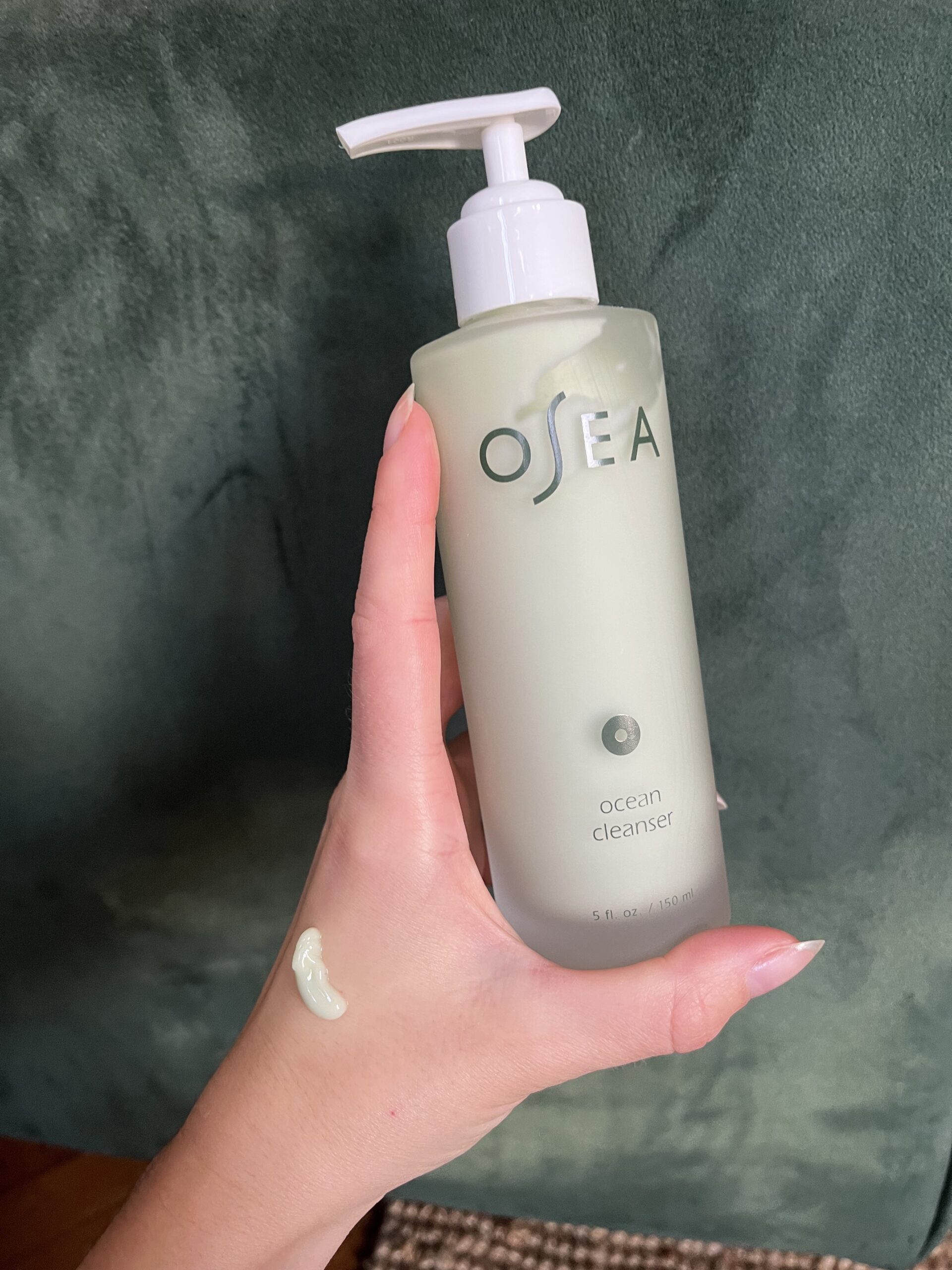 A hand holding Osea Ocean Cleanser