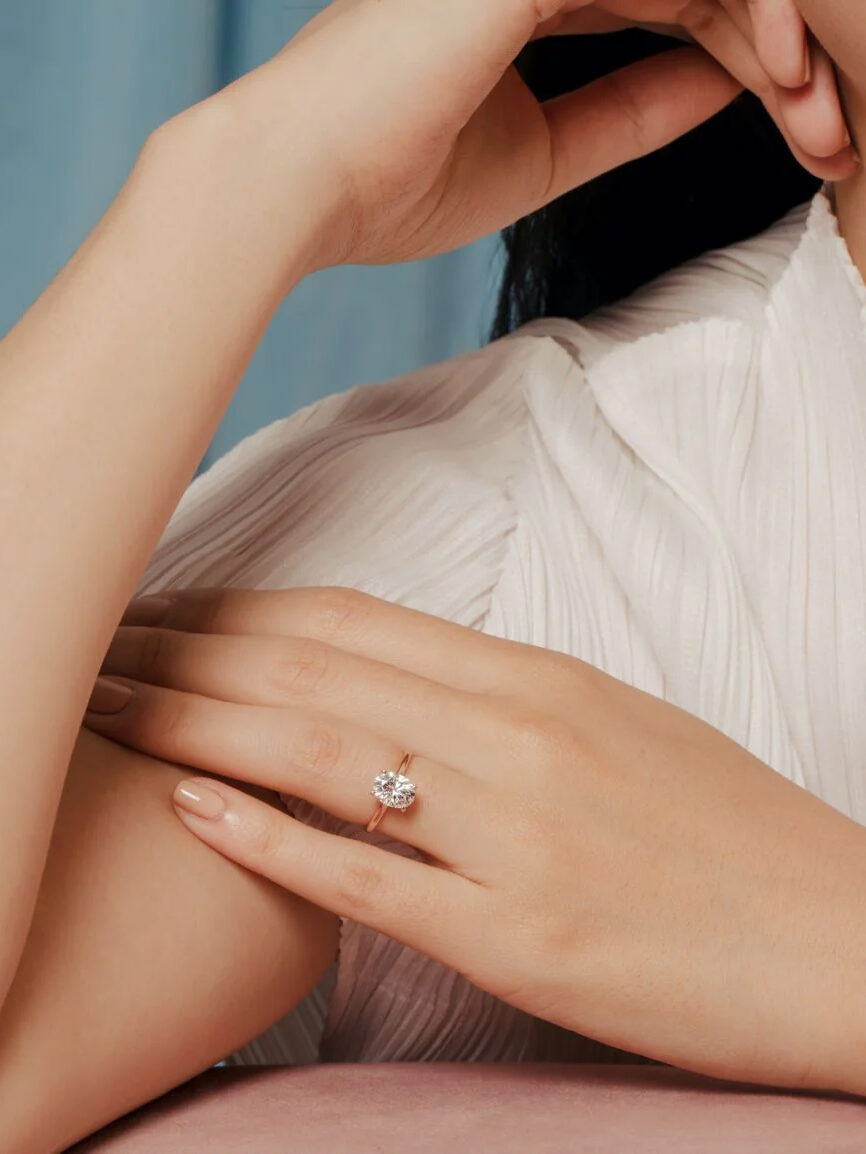 Close up of a moissanite ring on a model's hand from Gem & Co