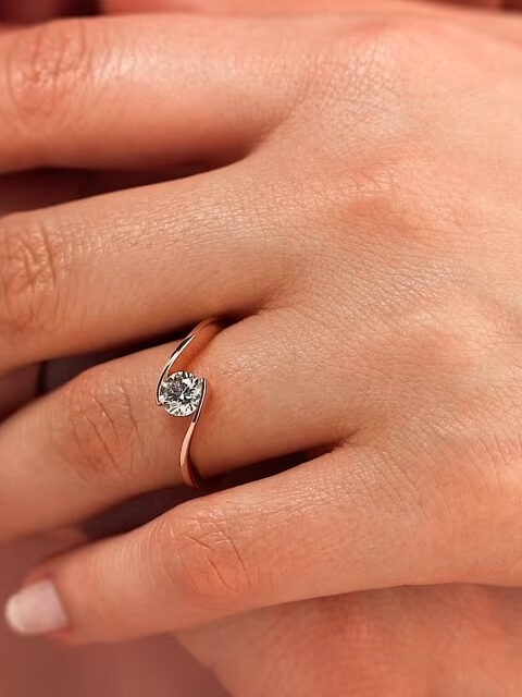Close up of a moissanite ring on a model's hand from Miadonna