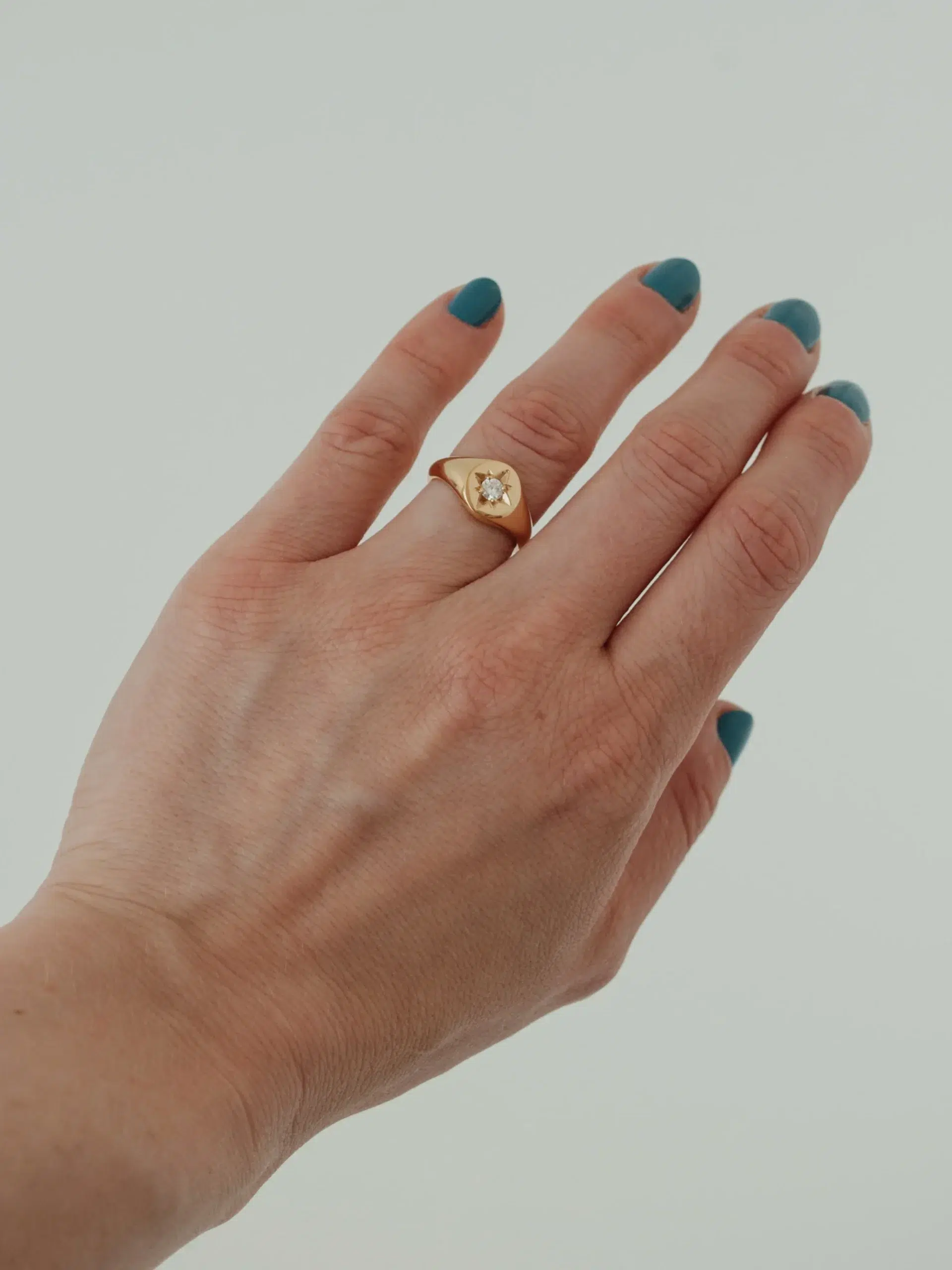 Close up of a moissanite ring on a model's hand from Apse
