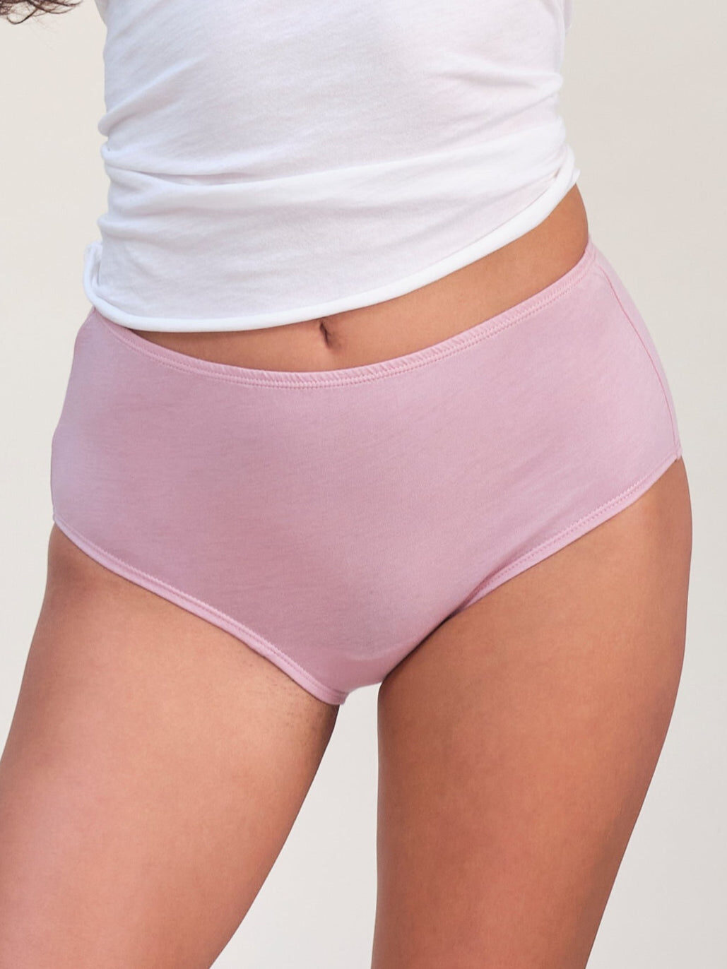 Close up studio shot of a model wearing Oddobody high waist underwear in pink.