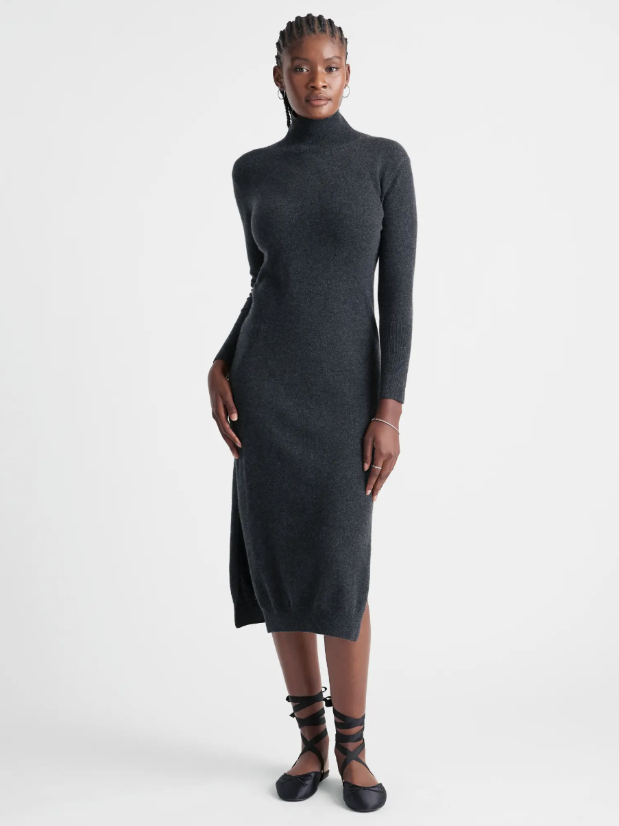 A model in a sweater dress from Quince