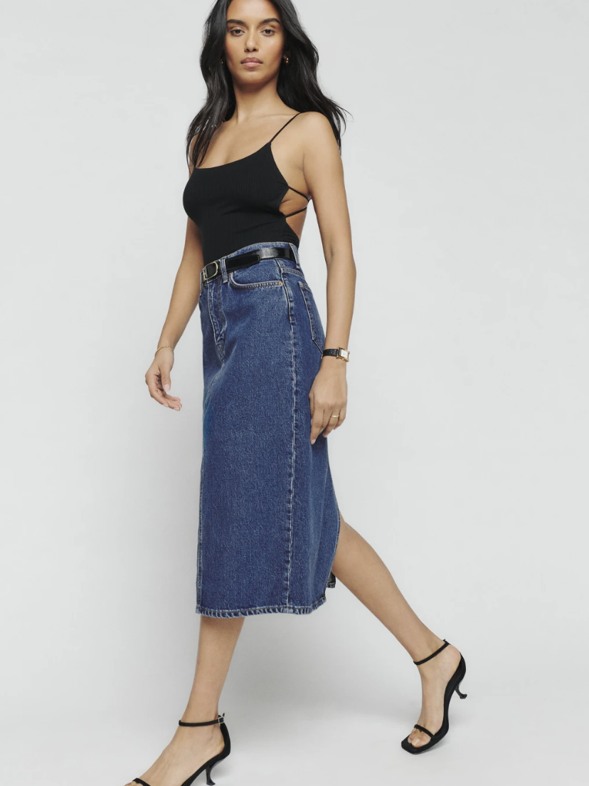 A model in a denim midi skirt from Reformation