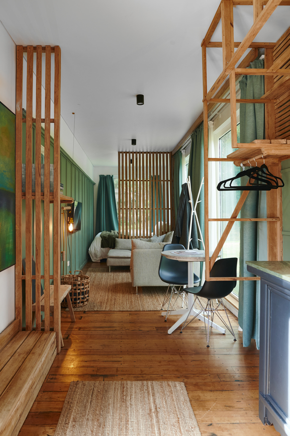 Interior of a tiny home with green walls and wood details