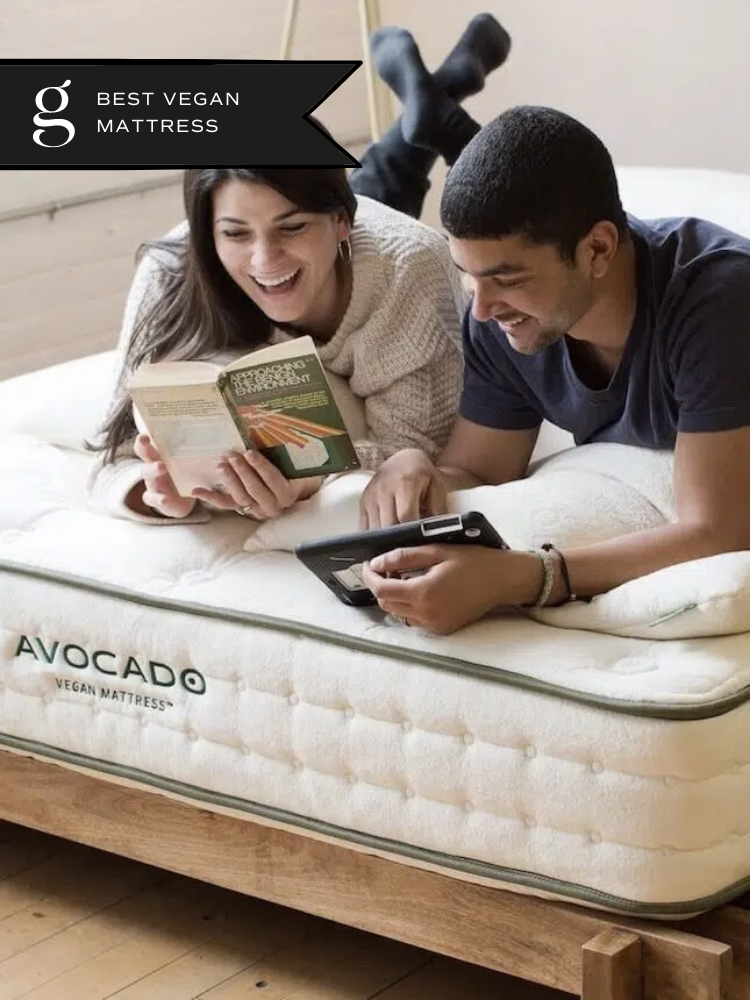 A couple reads and laughs on their vegan mattress by Avocado.