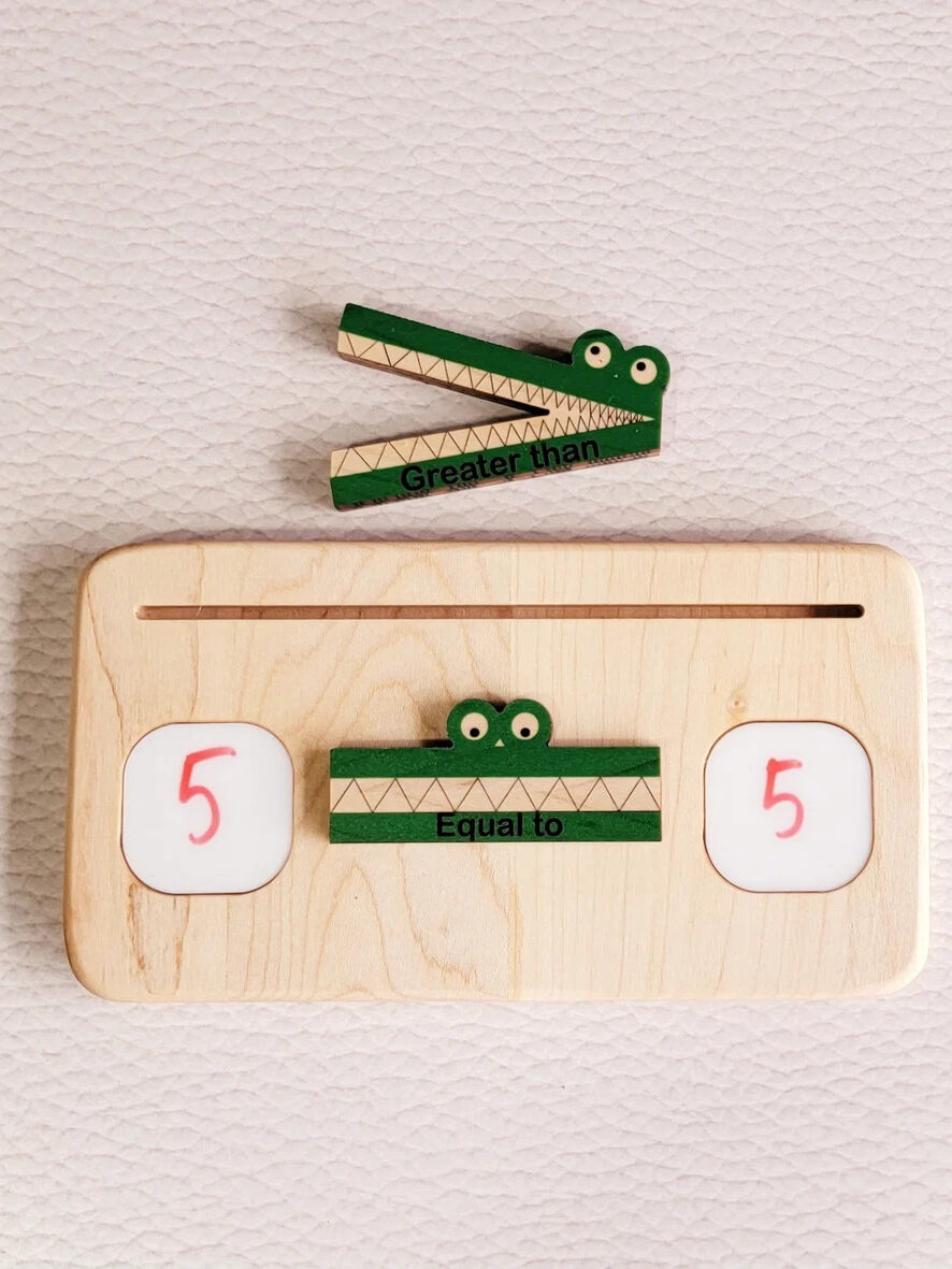 A Mirus Toy montessori greater than/less than alligator board.