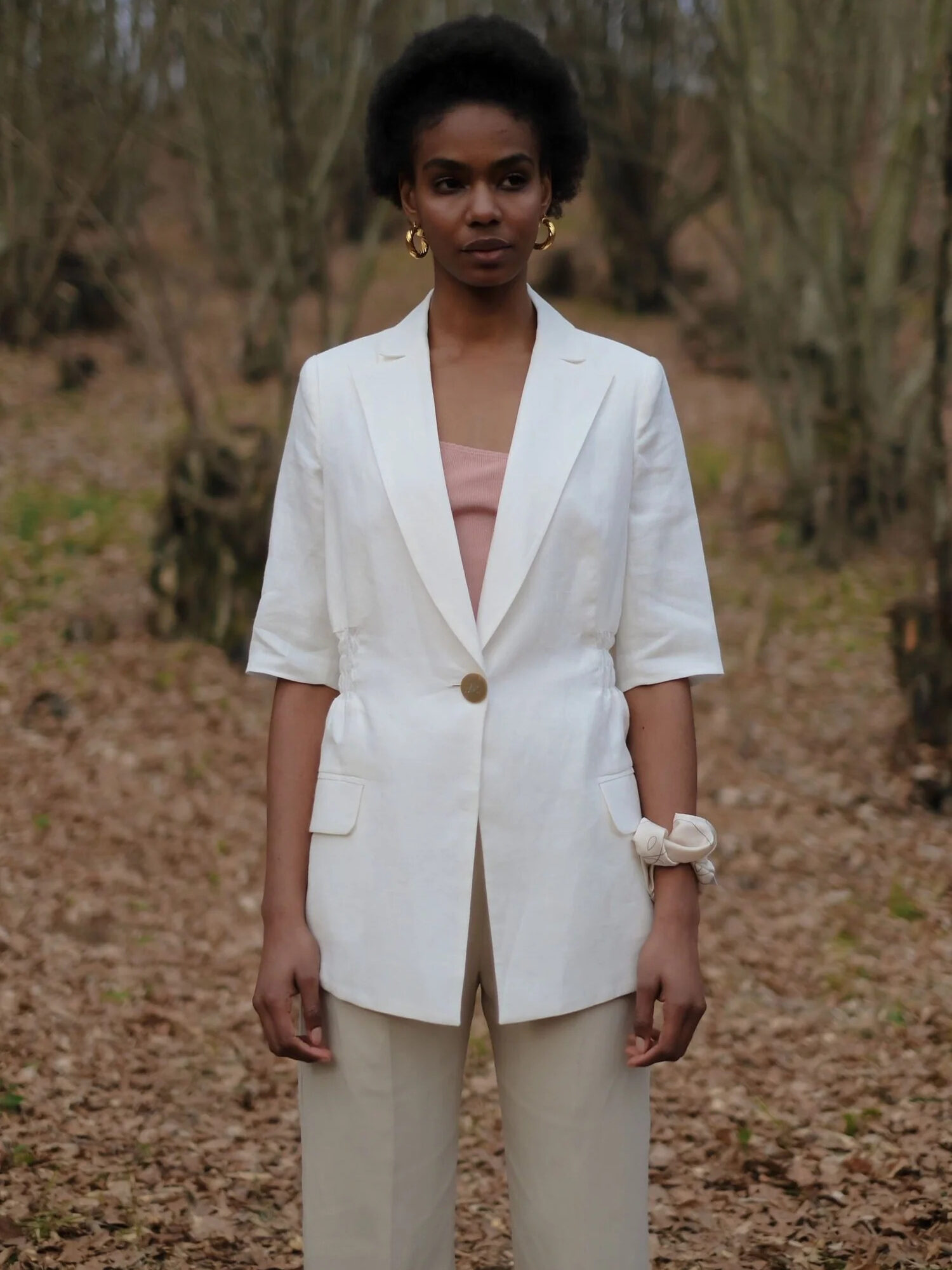 A model wearing OhSevenDays Thursday Bahama Blazer in white.